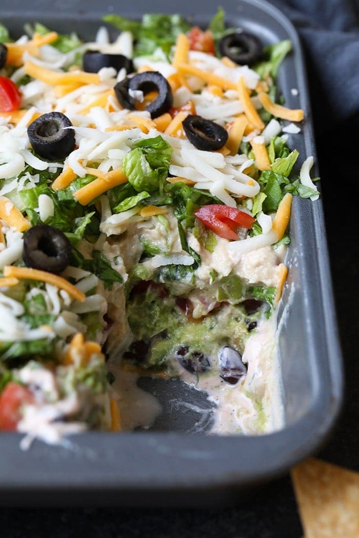 This Healthy 7 Layer Greek Yogurt Taco Dip is one of my favorite game-day appetizers of all time. It is easy, served cold, and perfect when you need to whip up a tasty dish for friends and family!