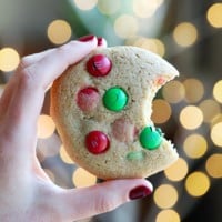 A person showcasing a healthier cookie adorned with M&M's.