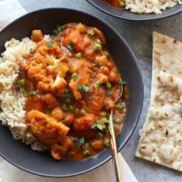 Cauliflower tikka masala curry with rice and naan.