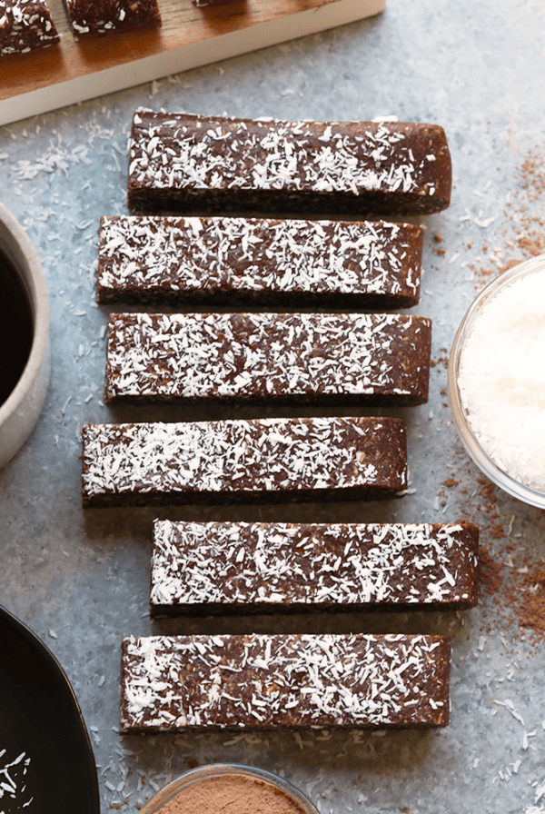 No-Bake Chocolate Coconut Energy Bars next to a cup of coffee.