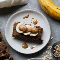 a plate with bananas, oats and peanut butter on it.
