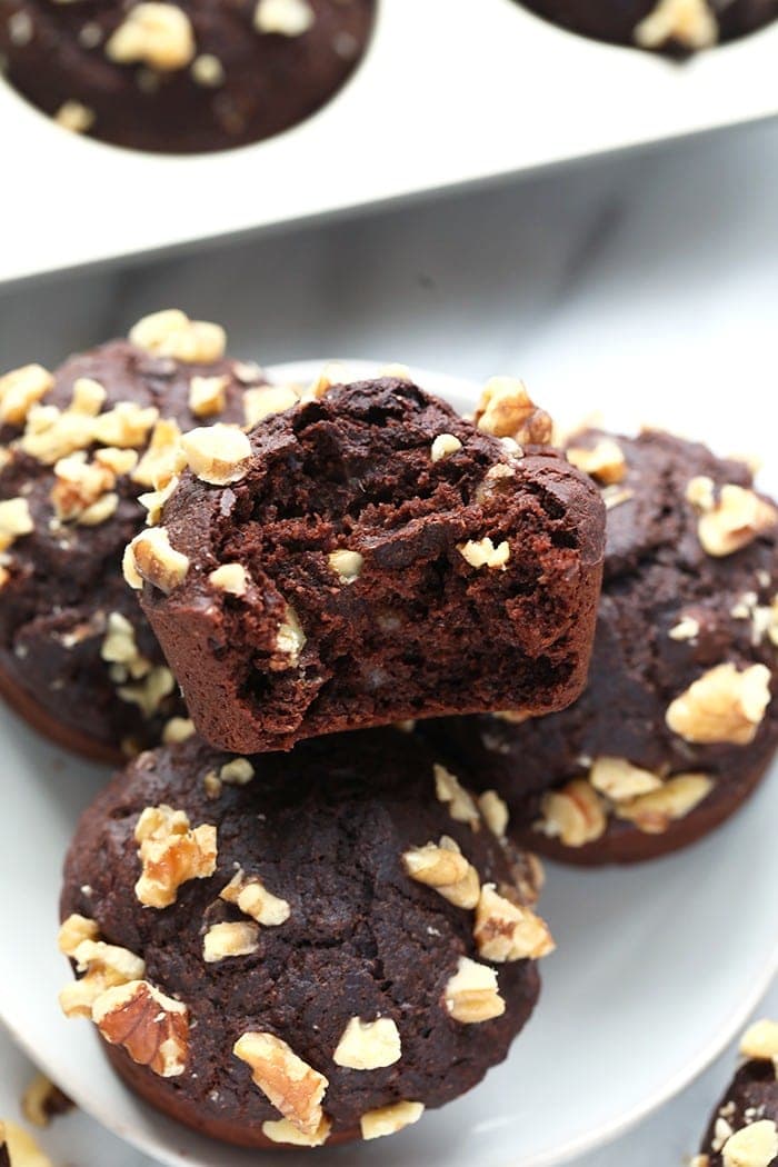 chocolate muffins on a plate with walnuts