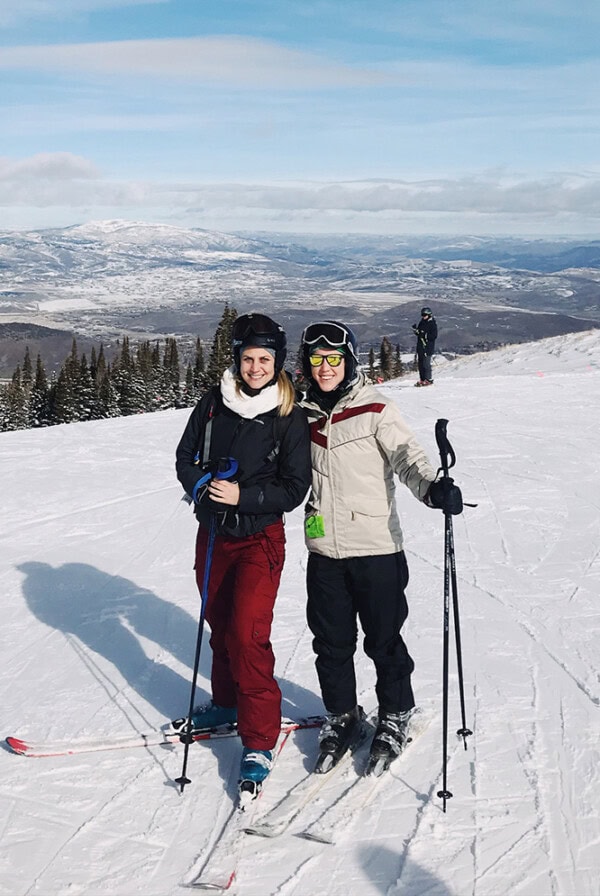 Two women on skis posing for a photo in Park City Ski Resort.