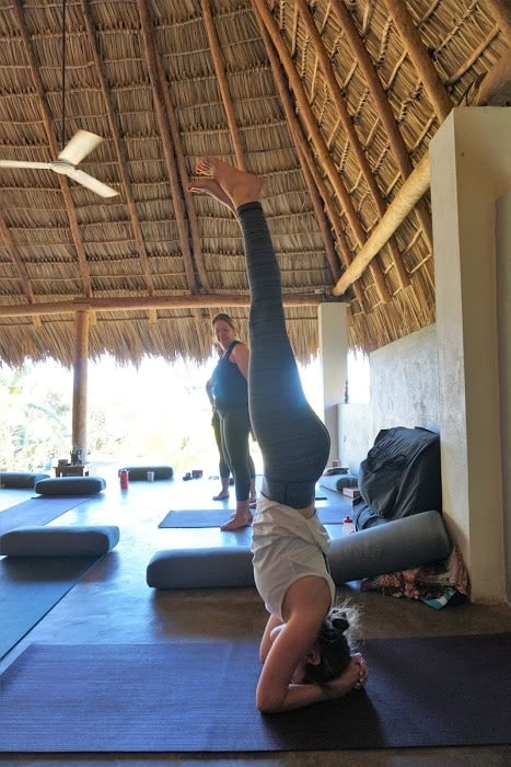 Person doing a headstand. 