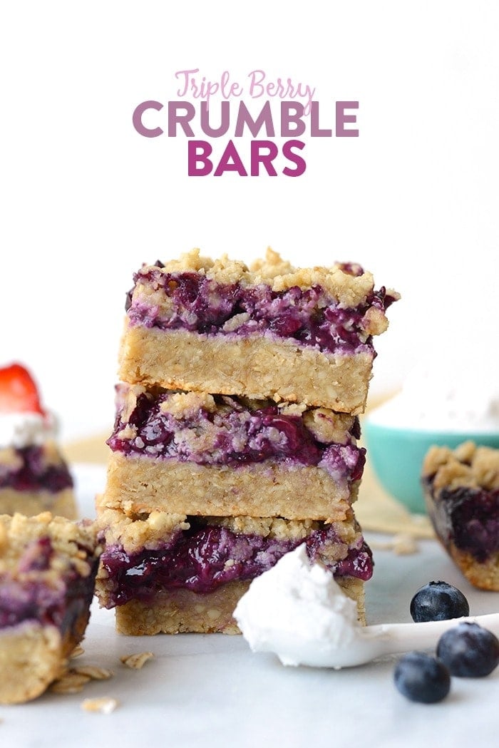 triple berry crumble bars stacked looking beautiful and delicious