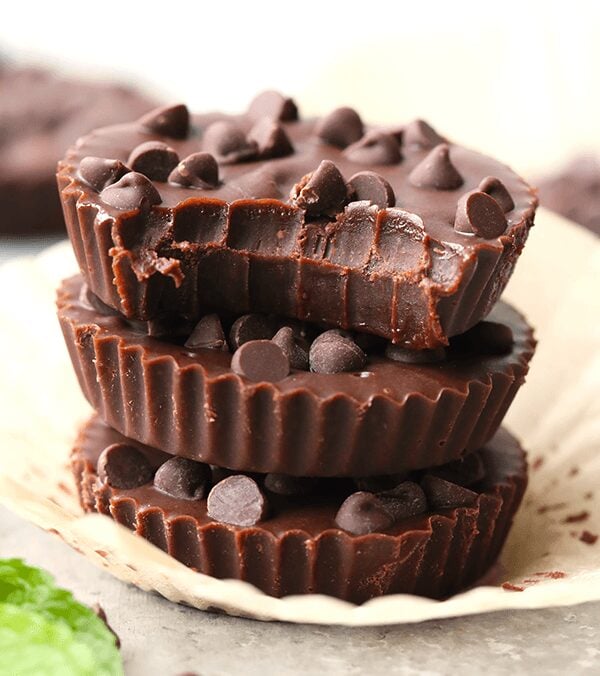 three almond butter cups stacked on top of each other with mint leaves.