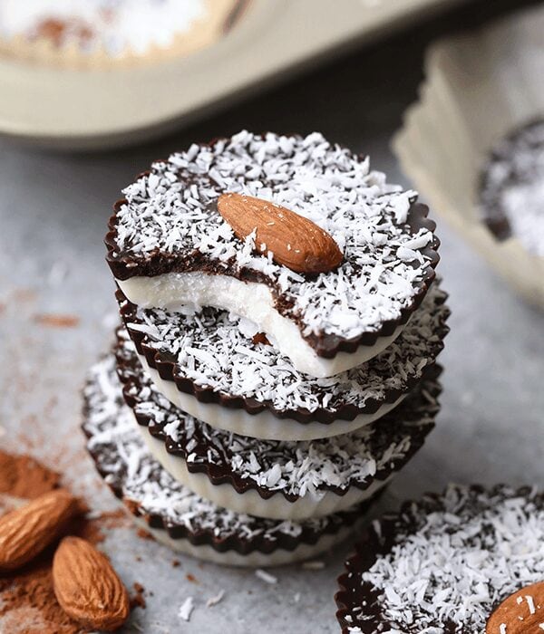 Stacked chocolate almond tarts topped with Coconut Butter Cups.