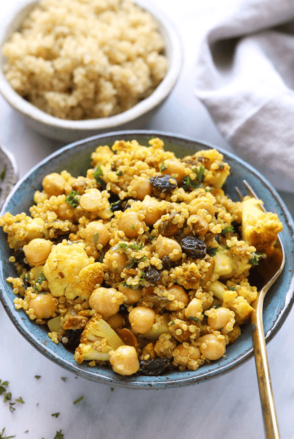 a bowl of golden roasted cauliflower and a bowl of couscous.