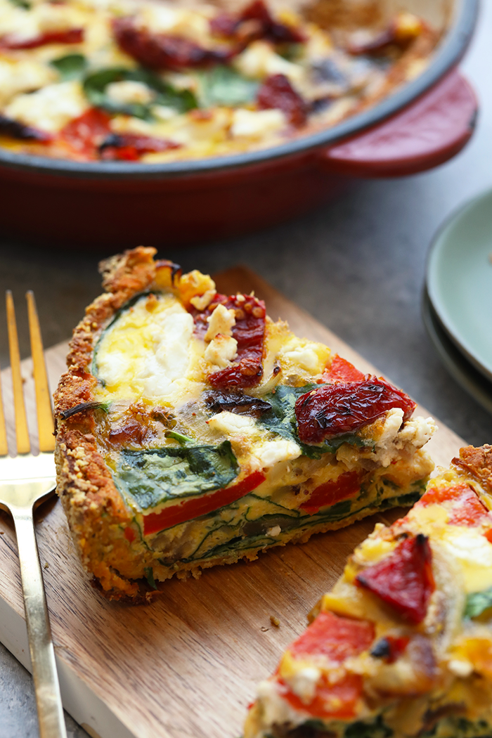 slice of quiche on cutting board