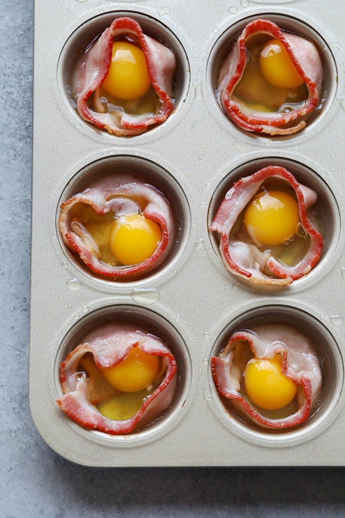 ،ing raw eggs into the middle of bacon