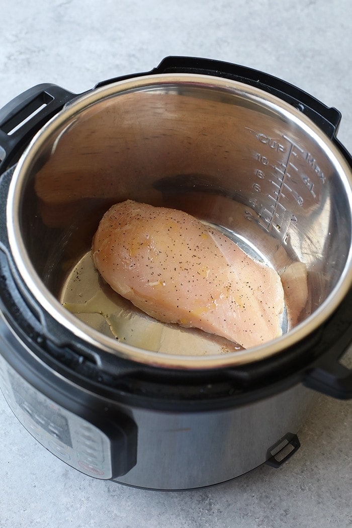 All you have to do is put your chicken in the Instant Pot for 8-12 minutes for an easy lunch or dinner prep all week long! raw chicken in the instant pot