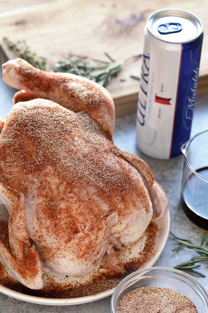 You only need a few ingredients to make this beer but chicken. Choose your favorite dry rub and fresh herbs! Ingredients for beery can chicken on the counter