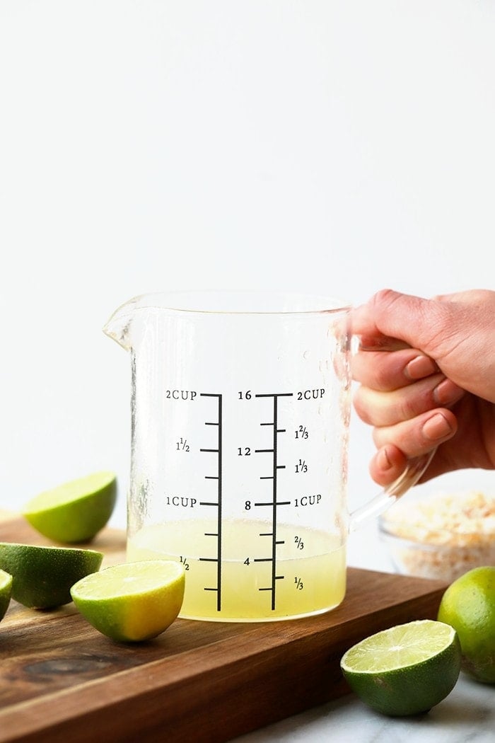 Measuring cup full of key lime juice