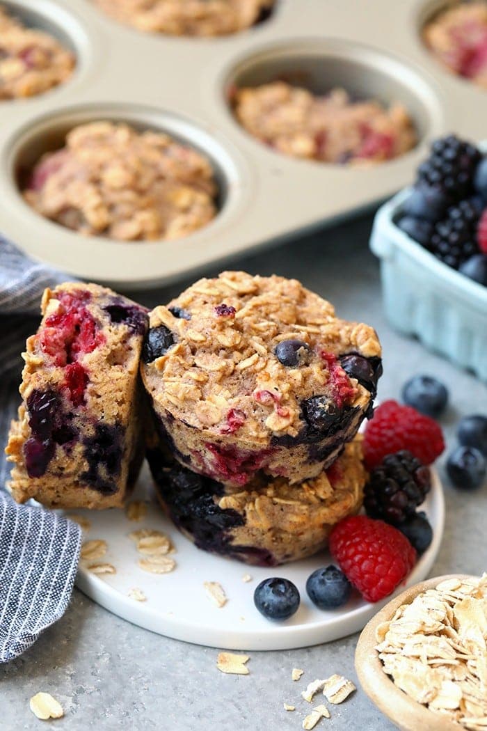 triple berry baked oatmeal cups stacked on a plate