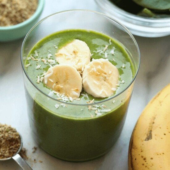 a green smoothie with bananas, spinach, and matcha powder.