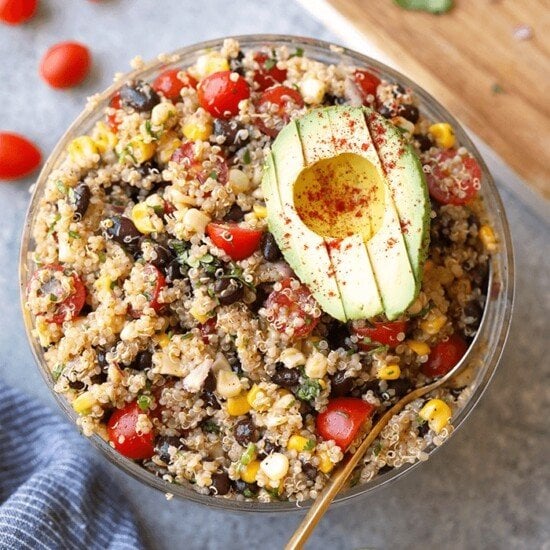 a flavorful bowl of Mexican quinoa salad featuring avocado and black beans.
