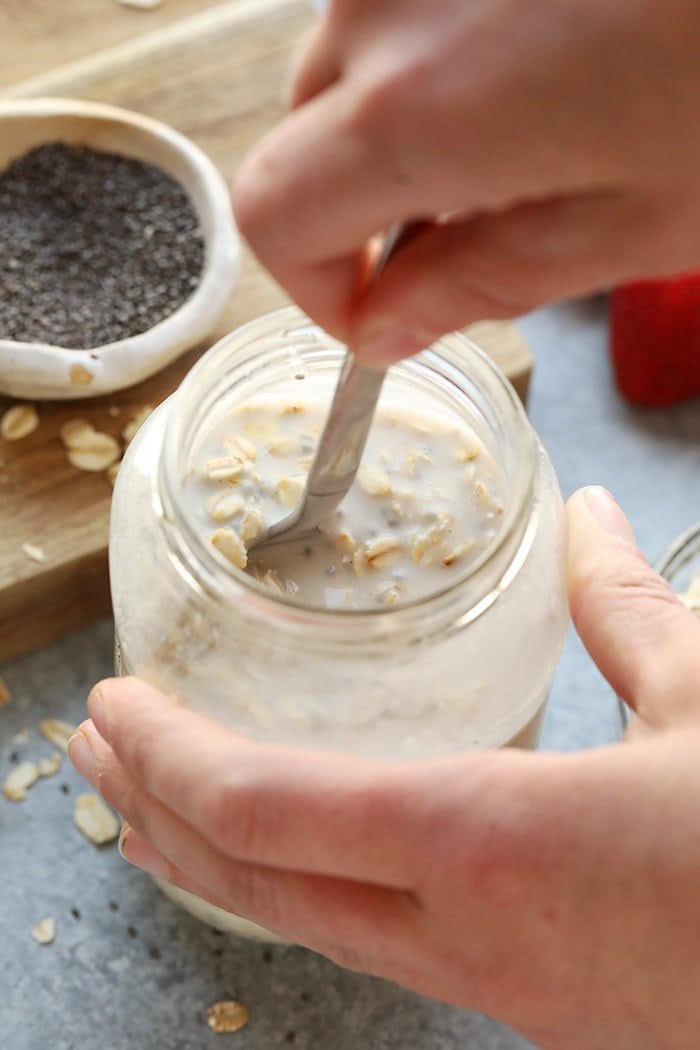 Overnight oats in a jar being mixed together.