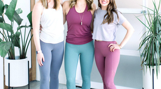 Three women posing for a photo in yoga leggings.