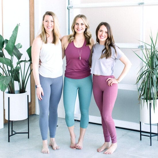 Three women posing for a photo in yoga leggings.