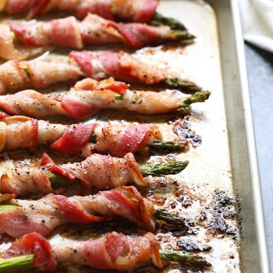 This bacon wrapped asparagus is a fun way to dress up your favorite veggie! You can make this bacon wrapped asparagus recipe for a tasty side dish for dinner or you can make them for an easy appetizer for a party. Either way, they're delicious!