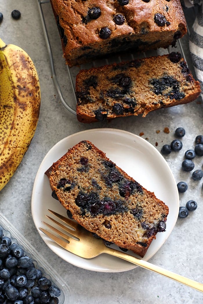 Slice of blueberry banana bread on a plate.