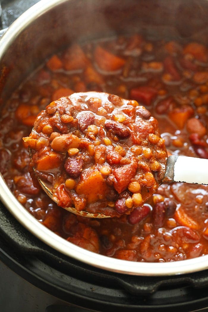 Instant Pot Vegan Chili on a ladle in the Instant Pot