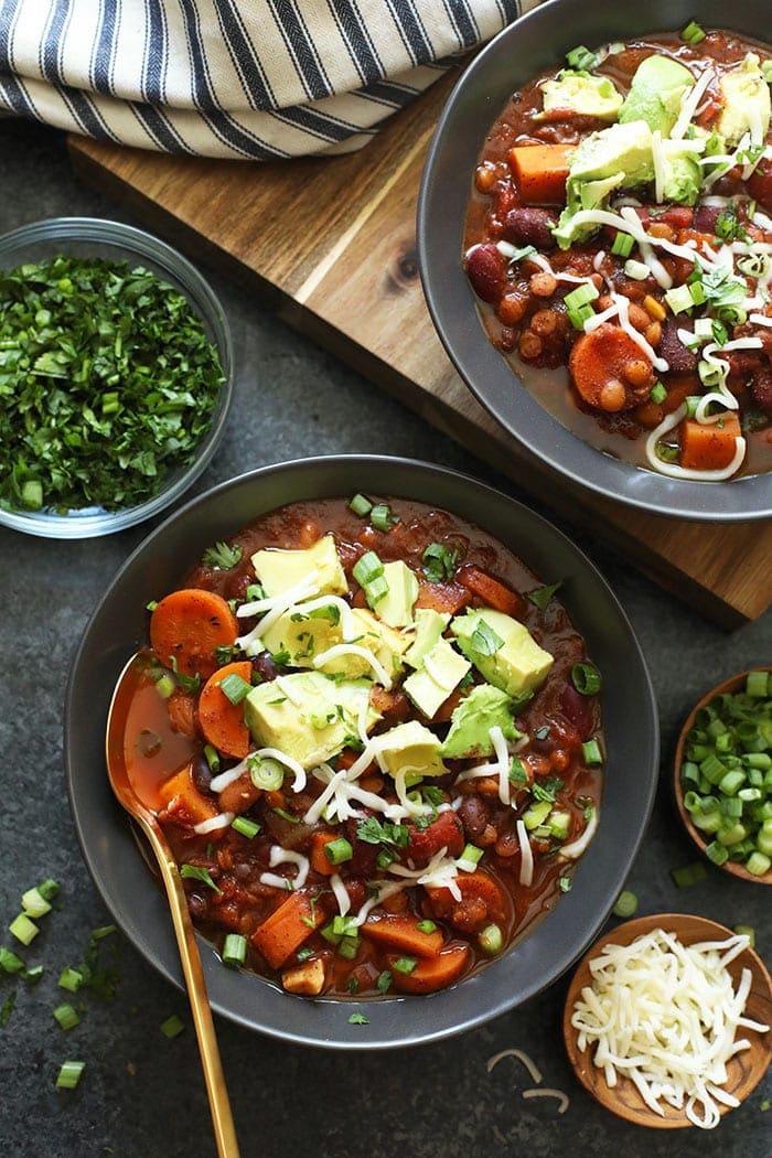 Instant Pot Vegan Chili in a bowl topped with vegan cheese and avocado