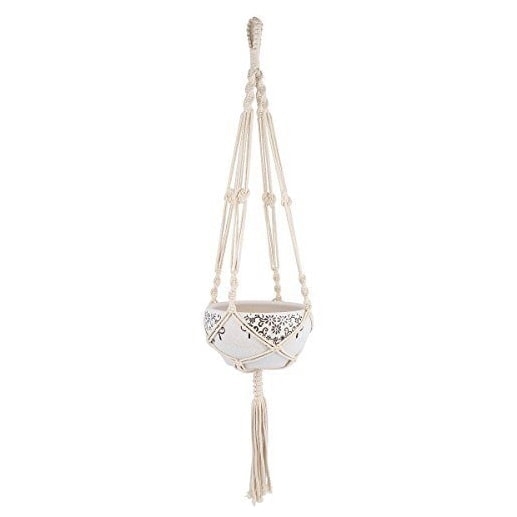A Macrame Plant Hanger with white tassels.