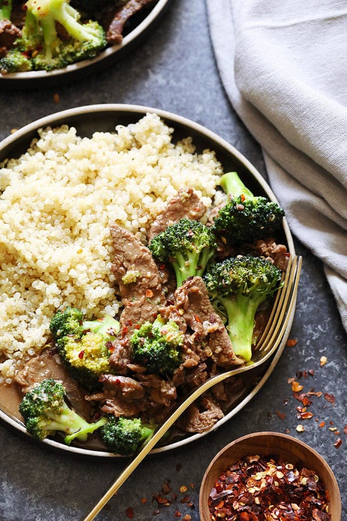 instant pot beef and broccoli on a plate with quinoa