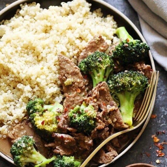 a plate of beef with broccoli and quinoa