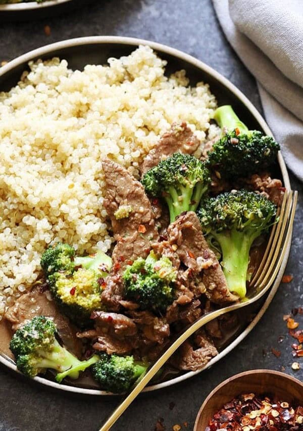 a plate of beef with broccoli and quinoa