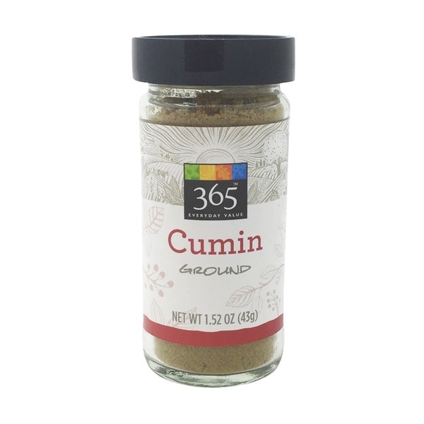 A jar of cumin, essential for flavorful taco soup, displayed on a clean white background.