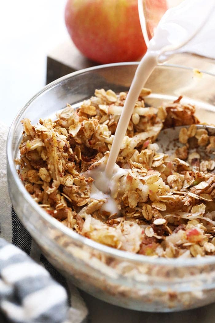 apple cinnamon overnight oats being mixed in a bowl