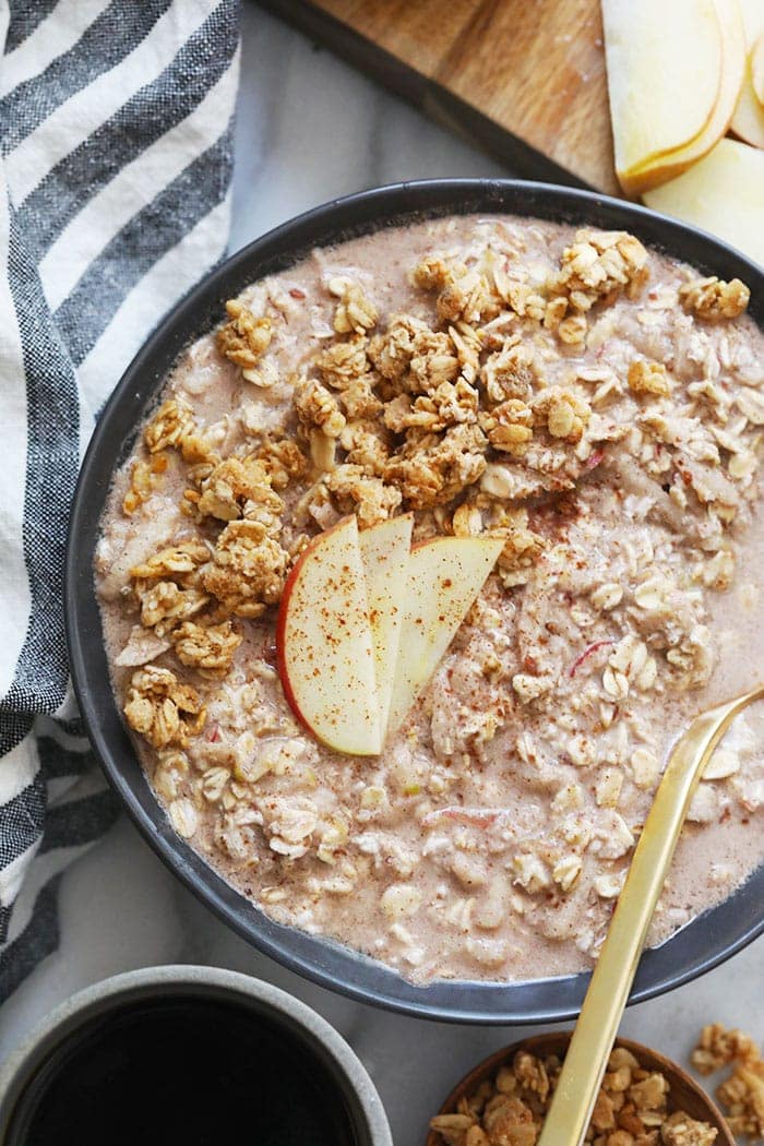 apple cinnamon overnight oats in a bowl topped with apple slices