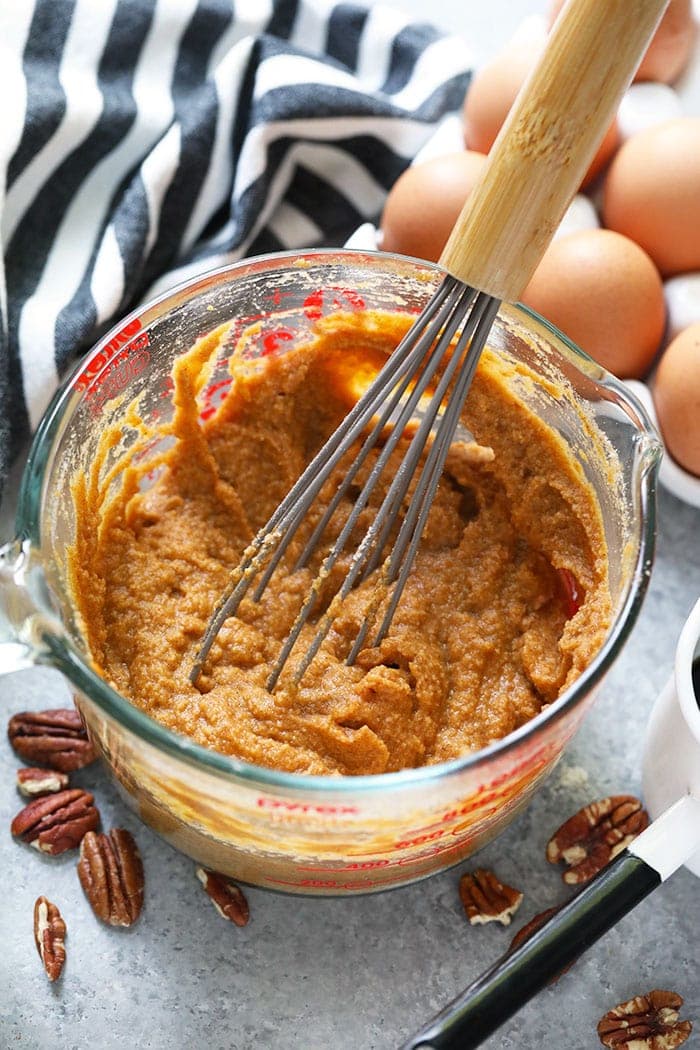 Pumpkin pancake batter in a bowl being whisked. 