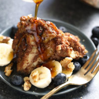 French toast with bananas and blueberries on a plate.