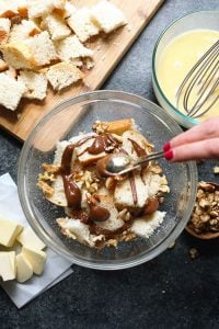 A person is mixing ingredients in a bowl.