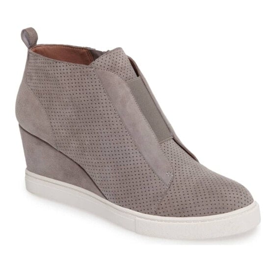 A women's grey wedge sneaker with a white sole.