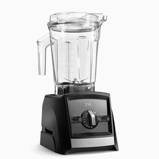 A black blender on a white background making a breakfast smoothie.