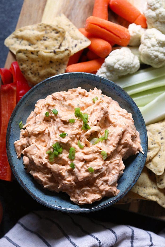 A bowl of buffalo chicken dip with fixings