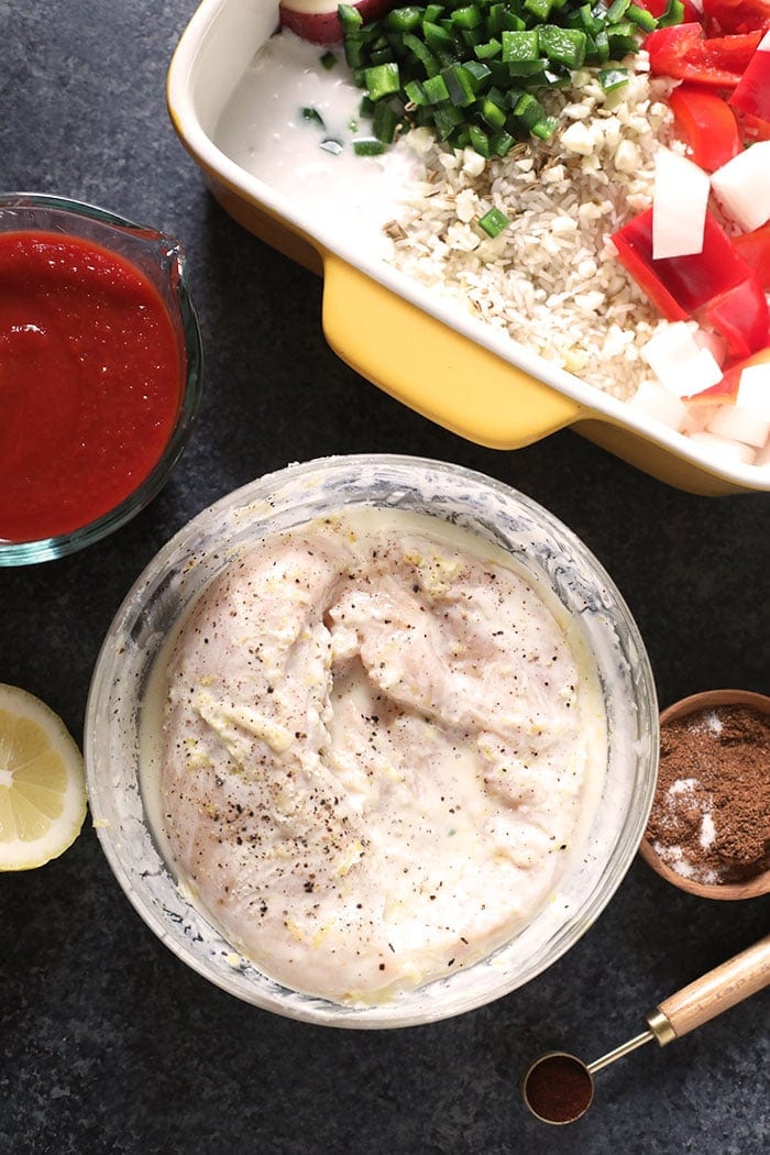 chicken marinating in a bowl