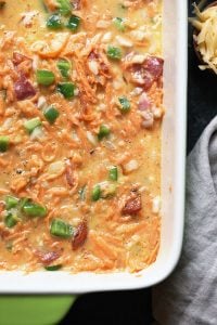 A healthy breakfast casserole with ham, cheese, and green onions.