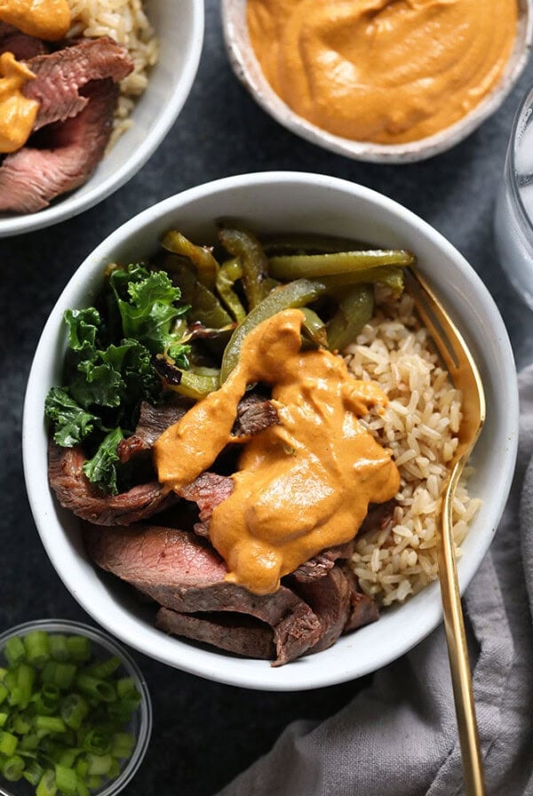 two bowls with Philly cheese steak, rice and sauce.