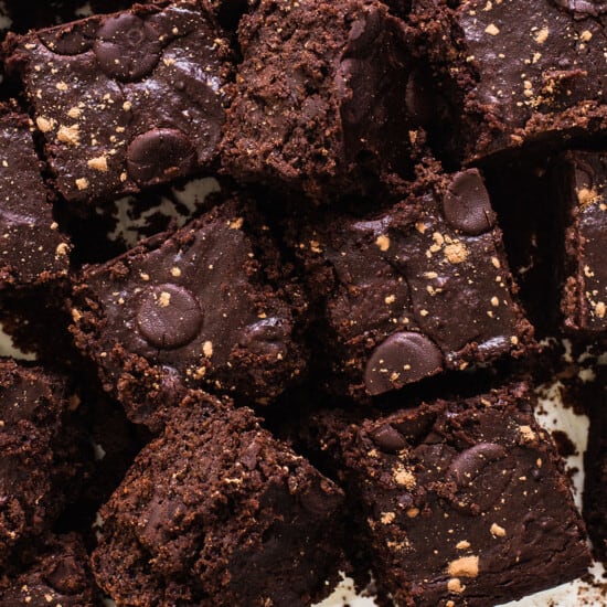 A pile of paleo pumpkin brownies on a white plate.