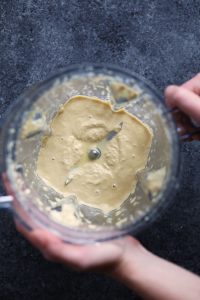 vegan person mixing a dough for mac and cheese in a bowl.