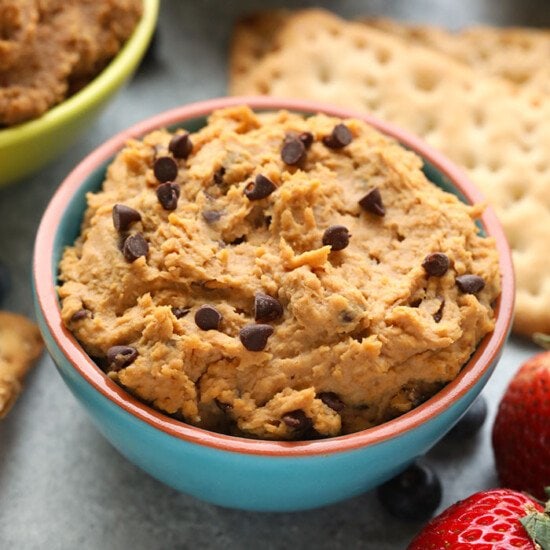 This chocolate chip edible cookie dough dip tastes exactly like Tollhouse cookie dough! It's made with a base of garbanzo beans, cashew butter, vanilla extract and sweetened with maple syrup. Throw in a handful of mini chocolate chips and you've got yourself one heck of a healthy edible cookie dough recipe!