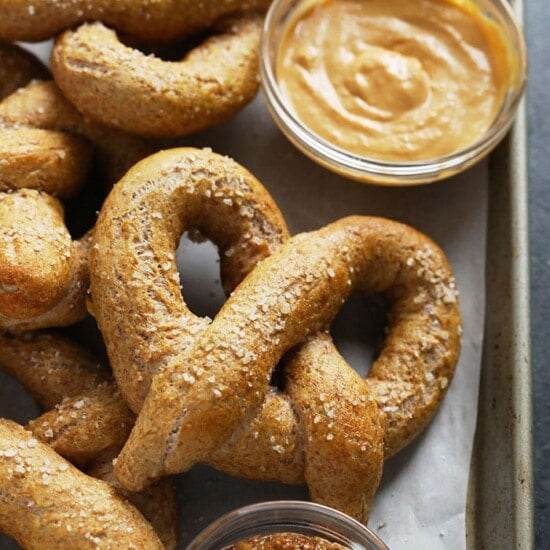 Soft pretzels with peanut butter on a tray.