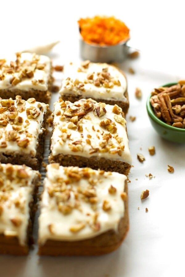 Healthy carrot cake bars with icing and pecans.