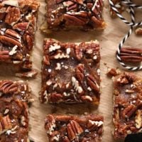 Easy pecan bars on a piece of paper.