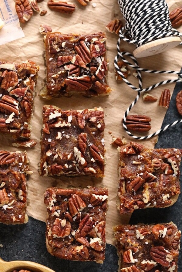 Easy pecan bars on a wooden cutting board.